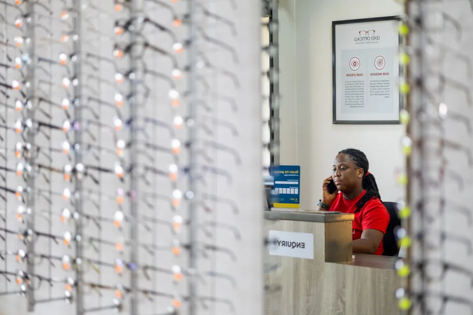 Eyewear displays and reception inside Lead Opticals in Oyarifa, Accra