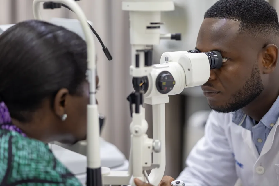 Optometrist examining a patient’s eyes at Lead Opticals in Oyarifa, Accra
