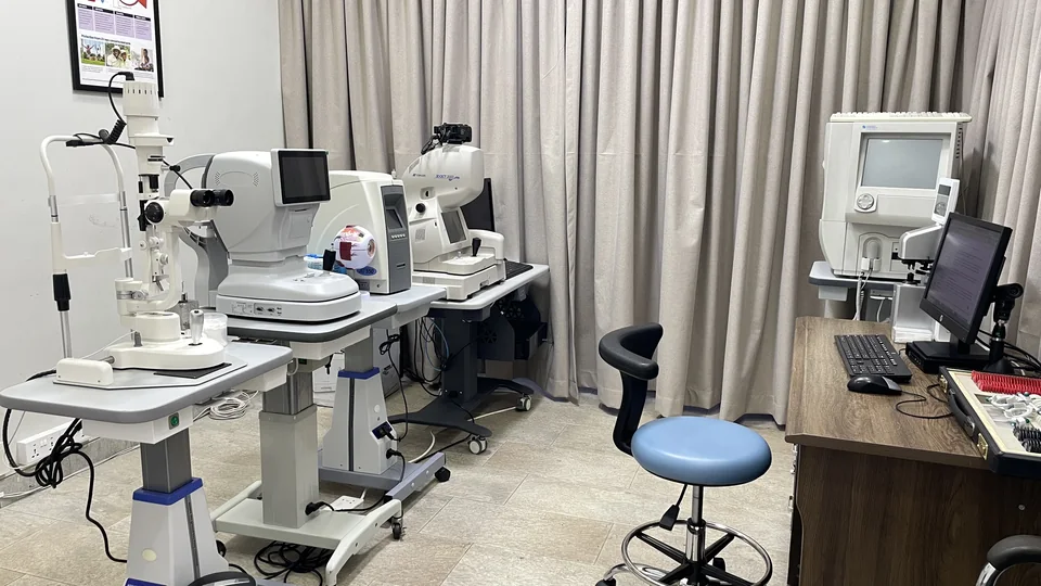 Consultation and diagnostic room at Lead Opticals in Oyarifa, Accra, with eye-examination and imaging equipment