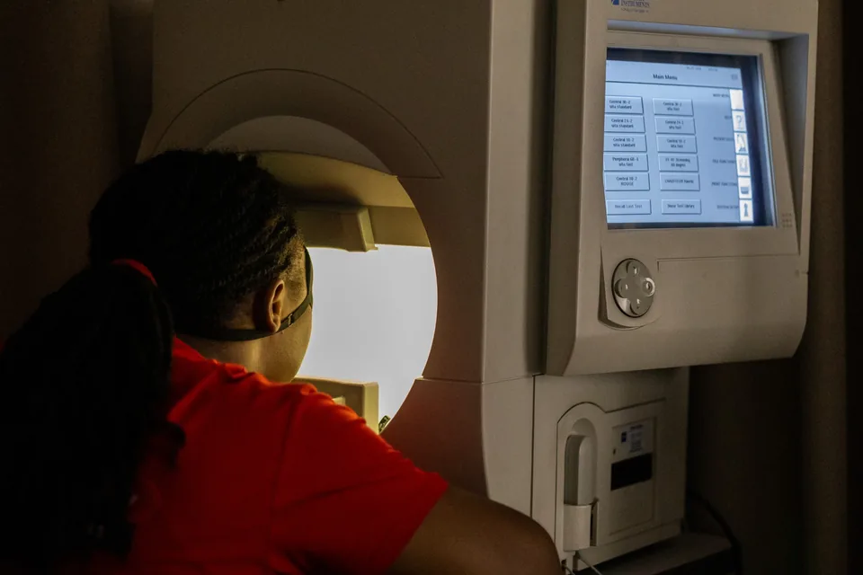 Patient undergoing visual field testing at Lead Opticals in Oyarifa, Accra